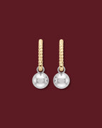 Back of the CHANTAL charm, a polished 14K white gold ball, on a 14K yellow gold twisted huggie