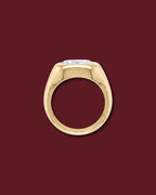 Yellow gold THALIA signet ring seen in profile, showing the marquise flush in the dome